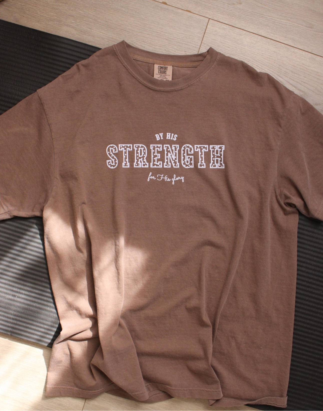 By His Strength Tee